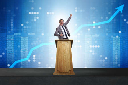 Man businessman making speech at rostrum in business conceptの写真素材