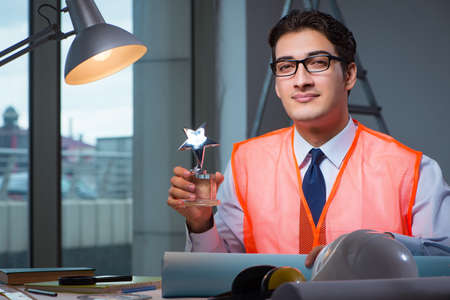 Construction architect working on drawings late at night