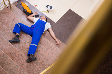 Dead contractor worker felling off the stairsの写真素材