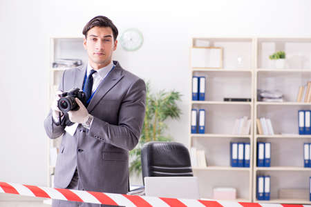 Forensics investigator at the scene of office crimeの写真素材