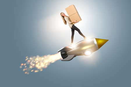 Woman in fast box delivery service on rocketの写真素材