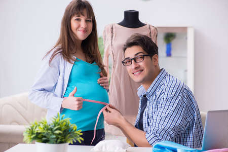 Pregnant woman visiting tailor for new clothing