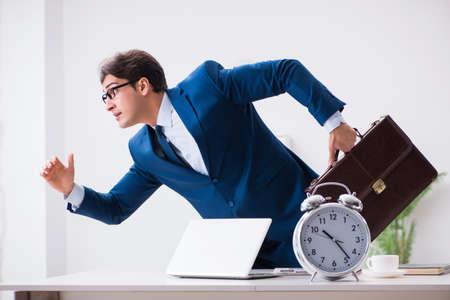 Businessman employee in urgency and deadline concept with alarmの写真素材