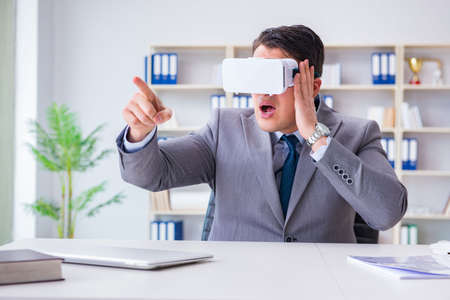 Businessman with virtual reality glasses in modern technology co