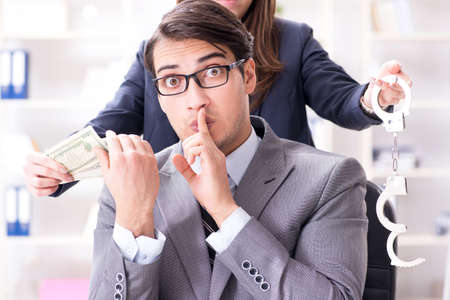 Businessmanbeing offered bribe for breaking lawの写真素材