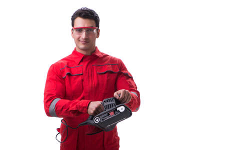 Young worker with belt sander sanding power tool isolated on whiの写真素材