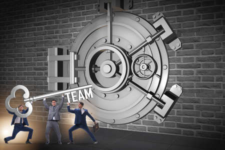 Businessman with key near bank vault doorの写真素材