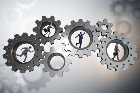 Teamwork concept with cogwheels and business peopleの写真素材