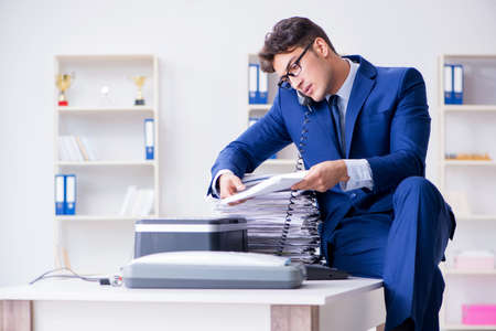 Businessman making copies in copying machineの写真素材