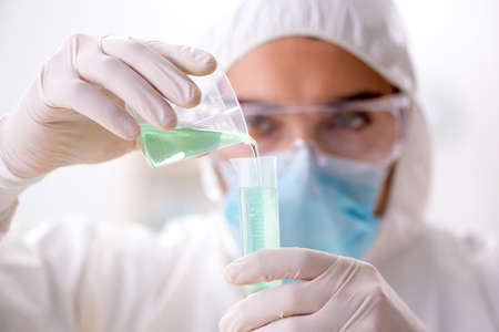 Young chemist student working in lab on chemicals