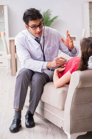 Pregnant woman patient visiting doctor for regular check-upの写真素材