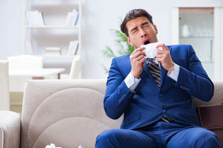 Sick employee staying at home suffering from flueの写真素材