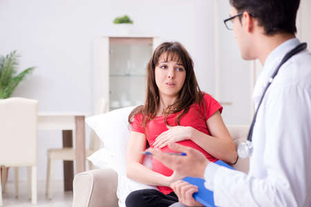Pregnant woman patient visiting doctor for regular check-upの写真素材
