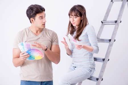 Young family doing renovation at home  - painting wallsの写真素材
