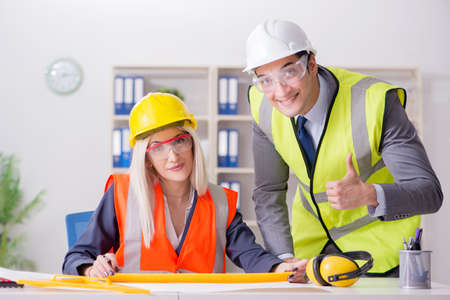 Construction workers having discussion in office before starting