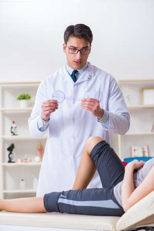 Doctor checking patients joint flexibilityの写真素材