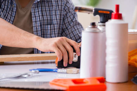 Young man in woodworking hobby concept