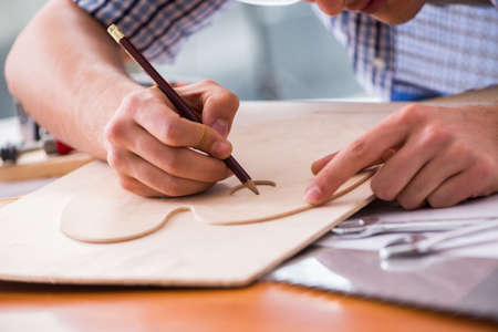 Young man in woodworking hobby conceptの写真素材