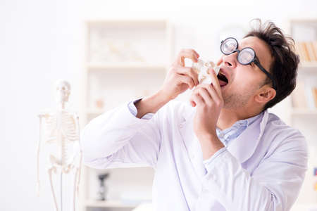 Crazy doctor studying human skeleton
