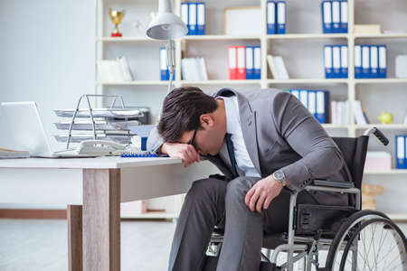Disabled businessman working in the officeの写真素材