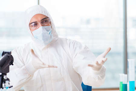 Young chemist student working in lab on chemicalsの写真素材