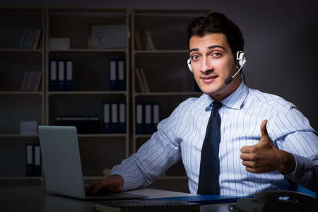 Call center operator talking to customer during night shift