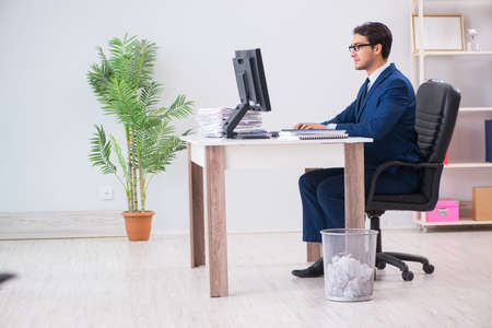 Young handsome businessman employee working in office at deskの写真素材
