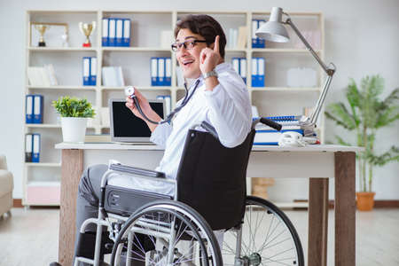 Disabled doctor on wheelchair working in hospitalの写真素材