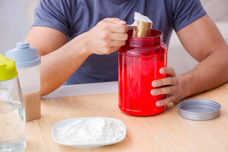 Athlete tasting new protein supplements for better musclesの写真素材