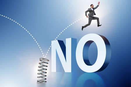 Businessman jumping from spring in business conceptの写真素材