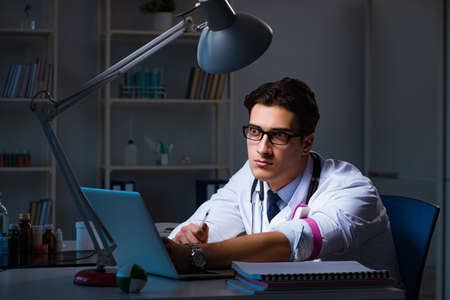 Doctor drug addict staying late on hospitalの写真素材