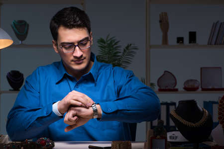 Jeweler working in his workshop late at night