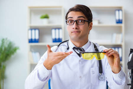 Safety doctor advising about wearing protective gogglesの写真素材