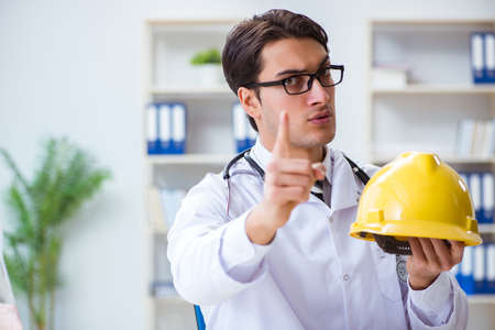 Safety doctor advising about wearing hard hatの写真素材