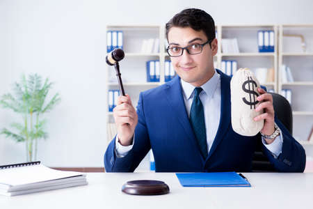 Judge in bribe concept with moneyの写真素材