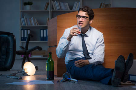 Stressed businessman working overtime in depression
