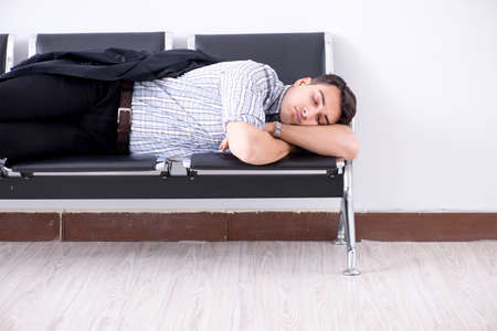 Man sleeping on the chairs in airport