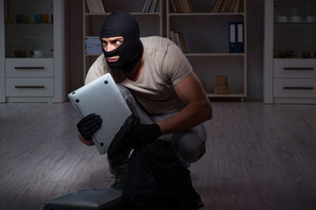 Burglar wearing balaclava mask at crime sceneの写真素材