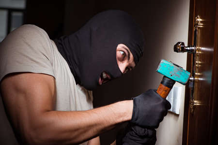 Burglar wearing balaclava mask at crime scene
