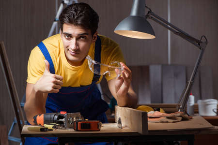 Worker working in repair workshop in woodworking conceptの写真素材