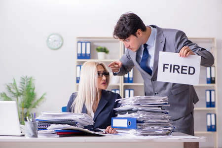 Angry boss firing his assistant secretaryの写真素材