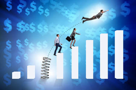 Business people jumping over bar chartsの写真素材