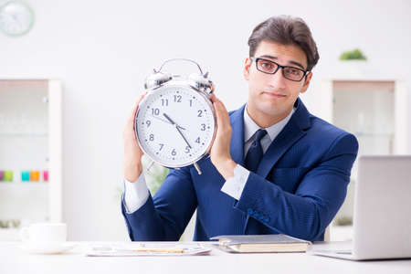 Businessman employee in urgency and deadline concept with alarmの写真素材