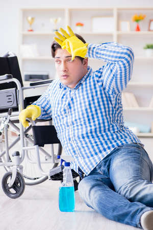 Disabled man on wheelchair cleaning homeの写真素材