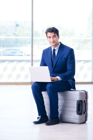 Businessman waiting for his flight at airportの写真素材