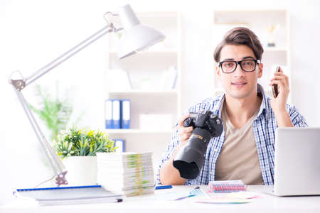 Young photographer working with his cameraの写真素材