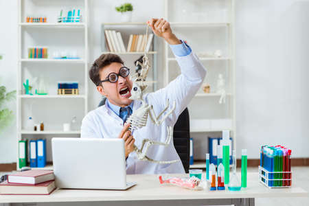 Funny scientist with cat skeleton in lab clinicの写真素材