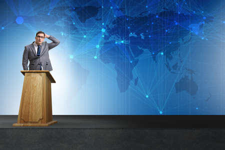 Man businessman making speech at rostrum in business conceptの写真素材