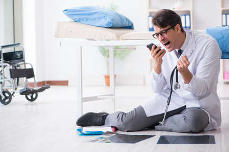 Doctor sitting on the floor in hospitalの写真素材
