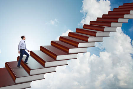 Businessman student climbing the ladder of education booksの写真素材